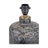 Close-up of the Vulcan textured volcanic effect grey stoneware table lamp base, showing a black E14 lamp holder with brass fitting atop a mottled grey ceramic body.