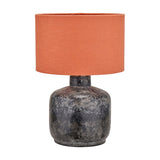 Vulcan table lamp with a rounded, textured volcanic-effect grey stoneware base and an orange fabric drum shade, shown on a plain white background.