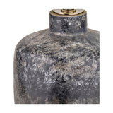 Close-up of the Vulcan textured volcanic effect grey stoneware table lamp base, showing mottled ceramic texture and a brass-toned fitting, on a white background.