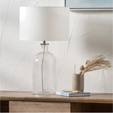 Bellamy Clear Bubble Glass Table Lamp, 53cm, with a white drum shade on a chrome fitting, styled on a wooden sideboard beside a vase and books.