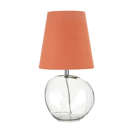 Hallie table lamp with a round clear glass base and tapered terracotta linen shade, shown on a plain white background.