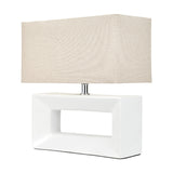 White ceramic rectangular table lamp with an open block base and rectangular linen shade, on a plain white background.