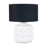 Serenity White Bobbled Ceramic Large Table Lamp with a navy drum shade, textured bubble-patterned base, on a plain white background.