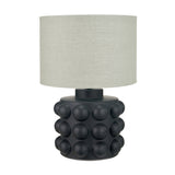 Table lamp with a matte black ceramic bobbled base and a light grey drum shade, shown on a plain white background.