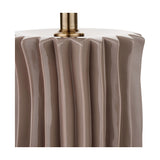 Close-up of the Devony Taupe Pleated Ceramic Table Lamp Base, showing vertical fluted ridges in glossy taupe ceramic with an antique brass fitting on a white background.