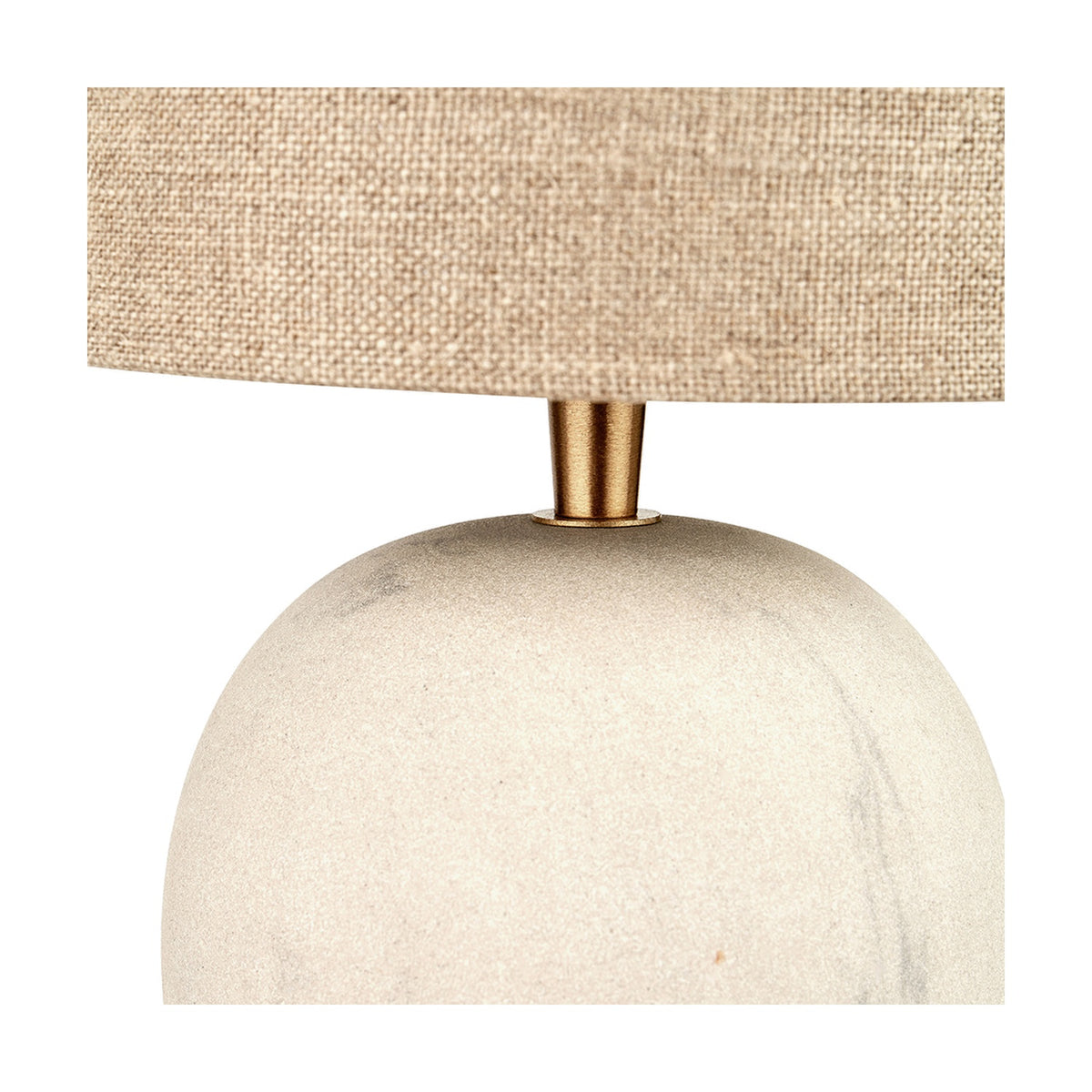 Close-up of the Althea Sandstone Table Lamp showing the rounded sand-coloured marble base, brass-finish neck fitting, and natural linen drum shade.