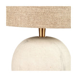 Close-up of the Althea Sandstone Table Lamp showing the rounded sand-coloured marble base, brass-finish neck fitting, and natural linen drum shade.