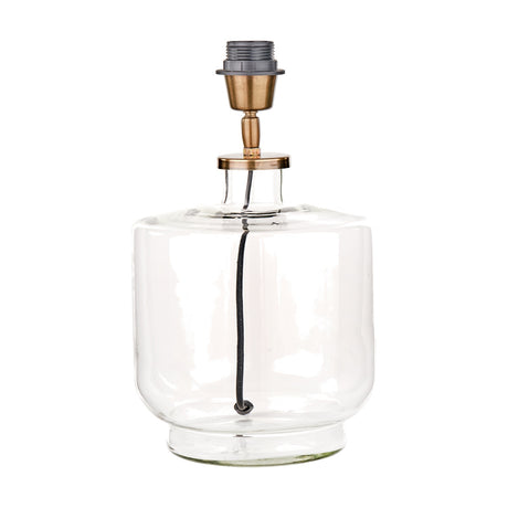 Josie table lamp base with a clear glass cylindrical body and antique brass fitting on top, shown on a plain white background.