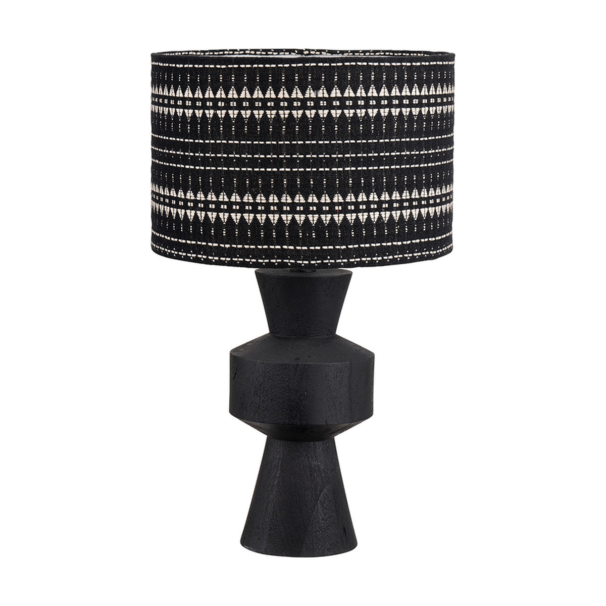 Koa Black Mango table lamp with a sculptural sectioned wood base and a black and white patterned drum shade, shown on a plain white background.
