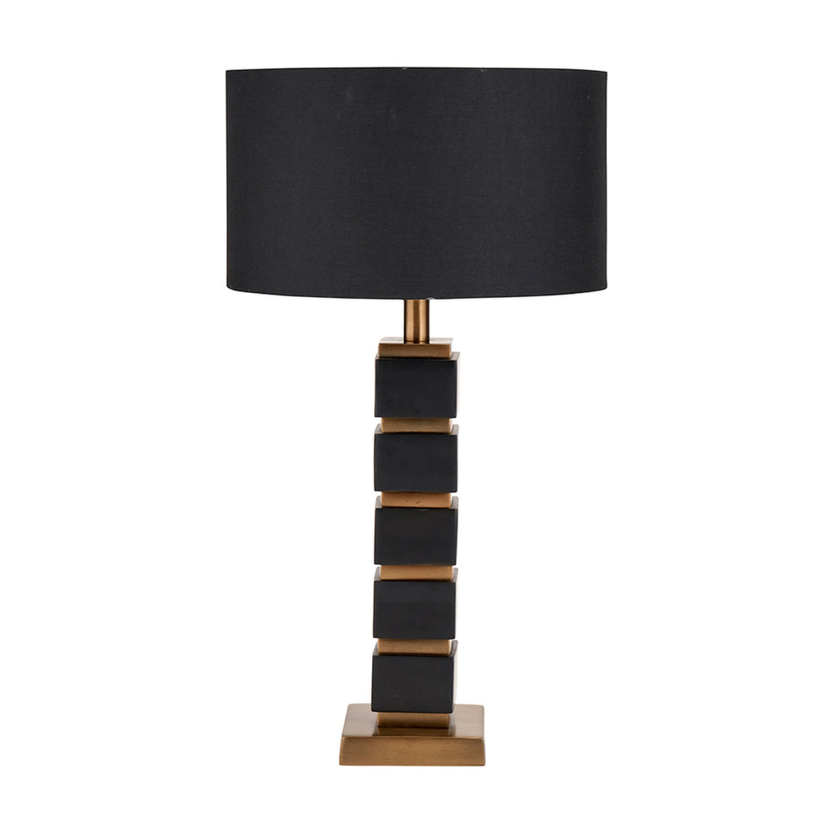 Maximo table lamp with a stacked cube base in matt black and antique brass, paired with a black drum shade, shown on a plain white background.