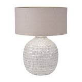 Signe table lamp, 58cm, with a rounded textured ceramic base in warm white and a drum-shaped linen shade in taupe, shown on a plain white background.
