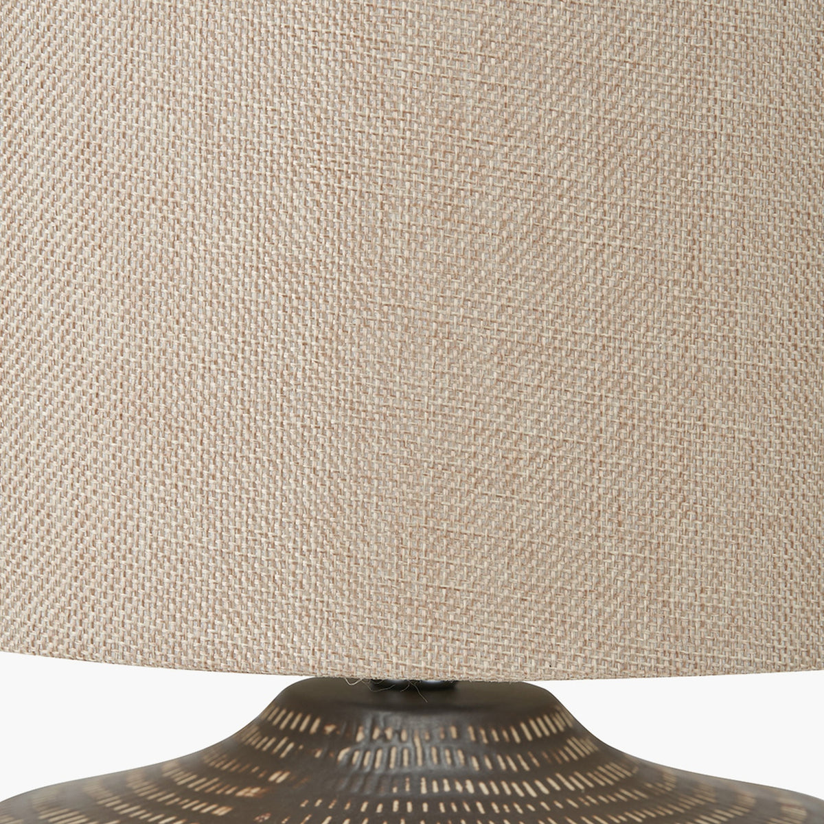 Close-up of the Kai Earth Brown Textured Ceramic Table Lamp, showing the woven beige linen drum shade above the textured brown ceramic base.