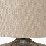Close-up of the Kai Earth Brown Textured Ceramic Table Lamp, showing the woven beige linen drum shade above the textured brown ceramic base.