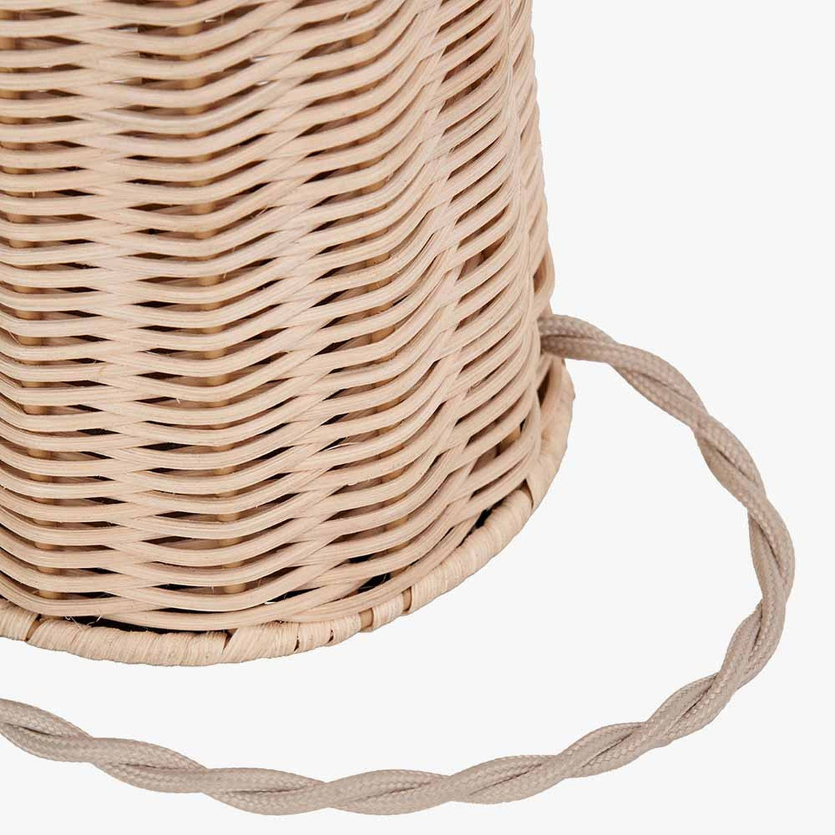 Close-up of the Hali rattan table lamp base showing woven texture and braided fabric flex cable, in natural brown finish against a plain white background.