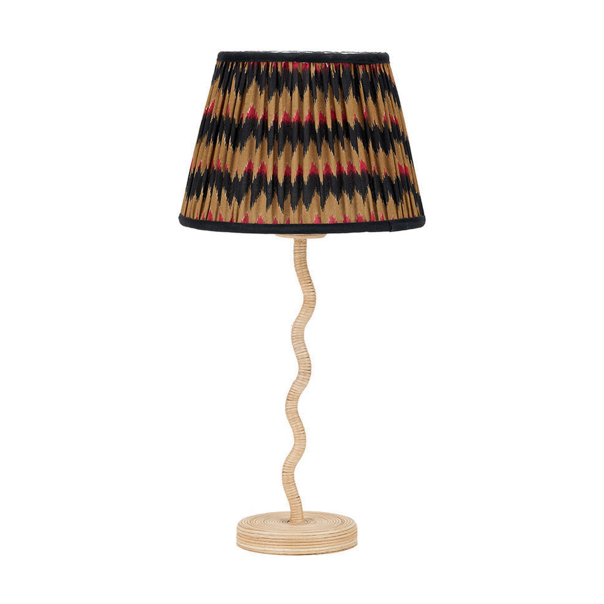 Palau Rattan Wave Table Lamp Base, 39cm, with a wavy natural rattan stem on a round ridged base, shown with a pleated black, tan and red patterned shade on a white background.
