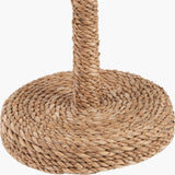 Close-up of the Leif Jute Rope Table Lamp base, showing tightly coiled natural rattan wrapped around a round base and cylindrical stem in a warm brown finish.