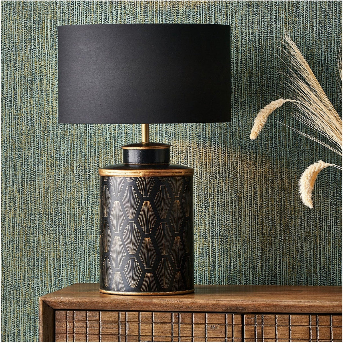 Chrysler Black Art Deco table lamp, 40cm, with gold fan-motif ceramic base and black rectangular shade, shown on a wooden sideboard against patterned wallpaper.