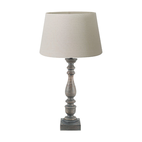 Alia table lamp with turned mango wood base in grey wash finish and cream calico tapered shade, shown on a plain white background.