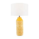 Bethan table lamp with a mustard yellow ceramic base featuring an embossed art deco fan pattern, topped with a white drum shade, on a plain background.