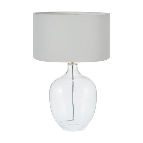 Islay table lamp with a clear bubble glass base and drum-shaped ivory cotton mix shade, shown on a plain white background.