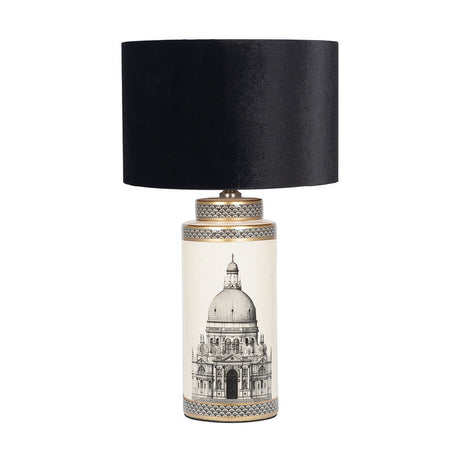 Wren tall ceramic table lamp with cream base featuring a monochrome cathedral print, black and gold trim, and a black velvet drum shade, on a plain white background.