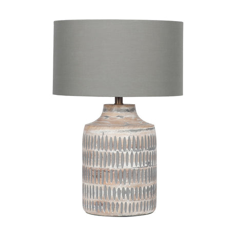 Galle table lamp with a grey wash textured wood base featuring carved ridge patterns and a grey cotton drum shade, on a plain white background.