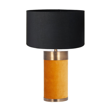 Dempsey table lamp with a cylindrical mustard velvet base, antique gold metal trims, and a black drum shade, shown on a plain white background.