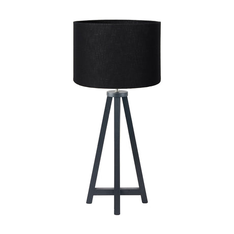 Whitby table lamp with matt black wood 4-post tapered base and black self-lined drum shade, shown on a plain white background.