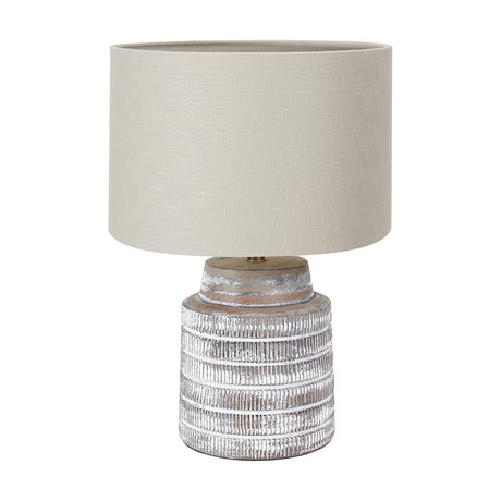 Paihia table lamp with a ridged white wash wood base and a grey drum linen shade, shown on a plain white background.