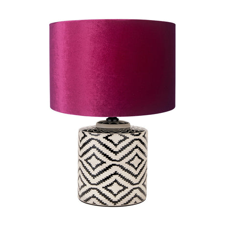 Chirala table lamp with a black and white ikat-patterned ceramic base and raspberry velvet drum shade, shown on a plain white background.