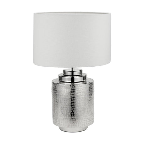 Zuri table lamp with a hammered silver metal cylindrical base and white linen drum shade, shown on a plain white background.