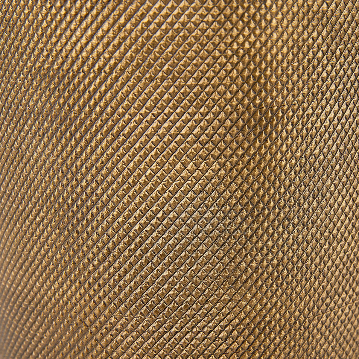 Close-up of the Aurelio Table Lamp Base's textured brass surface, showing a fine diamond-patterned finish in a warm golden-bronze tone.