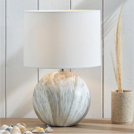 Viejo Grey Stone Effect Ceramic Table Lamp with round marbled ceramic base and white drum shade, styled on a wooden surface beside a stoneware vase and dried grasses.