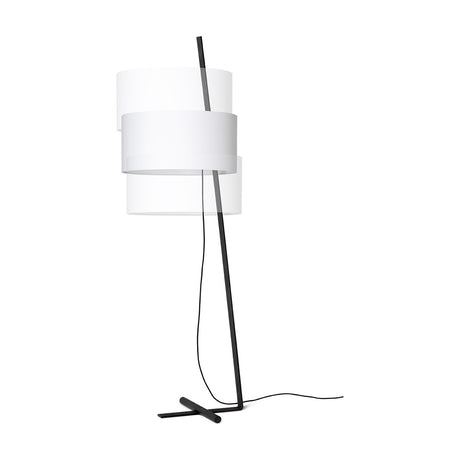 Gilvorne fabric floor lamp with tiered white cotton drum shade on a slanted anthracite iron stem and cross-shaped foot, shown on a plain white background.