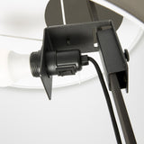 Close-up of the Gilvorne floor lamp's E27 bulb holder and anthracite iron bracket fitting inside the white cotton drum shade, showing wiring and mounting arm.