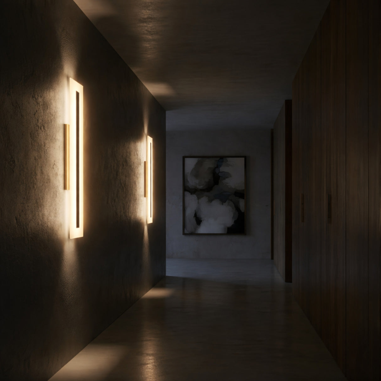 A dimly lit hallway features Averra LED Medium Rectangle Alabaster Wall Lights in Soft White & Brass on the left, a dark wall to the right, and an abstract black and white painting at the far end.