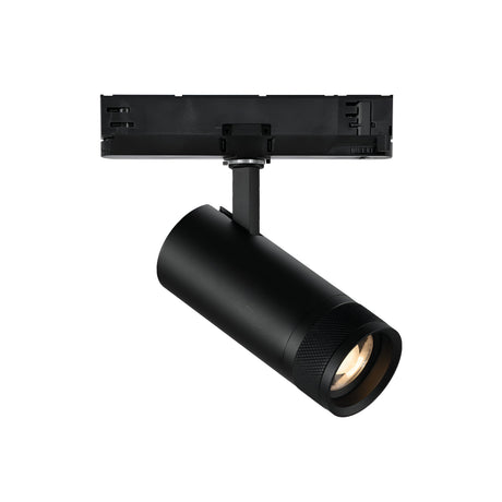 A black cylindrical track light fixture from the Solis Three Phase series is mounted on a rectangular track, featuring a dimmable LED spotlight that emits a warm 3000K color temperature. Its modern and sleek design is perfect for contemporary interior lighting, casting an inviting glow.