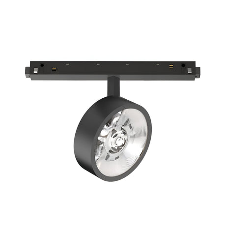 The Luxeon Dimmable LED Magnetic Track Spotlight 9W 3000K 1-10V in black features a round, transparent lens for precise directional lighting. Attached to a horizontal ceiling mount, its sleek modern design complements various interior spaces. With dimmable functionality and a warm 3000K glow, it creates the perfect ambiance.