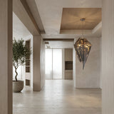 Niori Shard 8 Light Smoked Glass Chandelier in black hangs from a wood-panelled ceiling in a minimalist hallway with light oak floors and a potted olive tree.