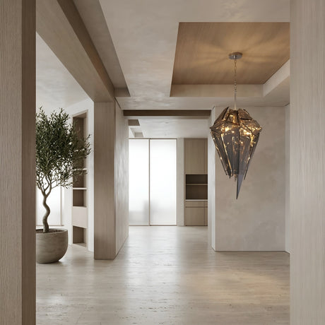 A modern, minimalist interior with light wood floors, built-in shelves, a potted tree, and the Shard 8 Light Smoked Glass Suspension Light - Black as a striking geometric centerpiece creates a serene and elegant atmosphere.
