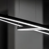 Close-up of the Arcena Round LED Suspension Light showcasing a modern, abstract design with long, slender LED tubes against a dark background. These energy-efficient lights provide an industrial look and create a stark contrast with their glowing white light.