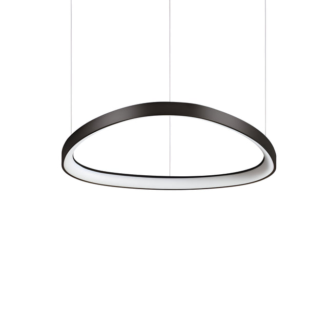 A sleek Zephra Dimmable LED Light Suspension 48W 3000K - Black, 61cm, hangs from the ceiling against a plain white background. Its modern black oval design features an inward-facing light source that casts a soft glow inside the ring.