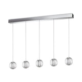 The Lustris 5 Light LED Bar Pendant features five spherical bulbs, each elegantly encased in a textured wire mesh with acrylic diffusers to ensure even illumination. These bulbs are suspended in a linear arrangement from a sleek rectangular base, providing energy-efficient lighting with a contemporary and minimalist design. This modern light fixture has an output of 27W at 2000K and comes in a stylish silver finish.