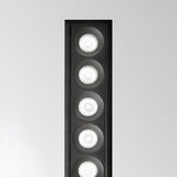This close-up highlights the slender design of the Phosix Slim LED Recessed Downlight - 10W, 3000K, in black, showcasing six vertically arranged round lights that demonstrate energy-efficient lighting against a plain white background.