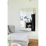 Connect I frameless rectangular wall mirror, 150cm, with printed black brushstroke design reflecting a living room with fireplace and grey sofa.