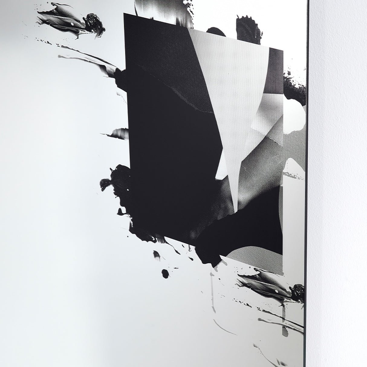 Angled close-up of the Connect III frameless glass wall mirror, 105cm, with a torn black printed form revealing a greyscale photographic image beneath, mounted against a white wall.