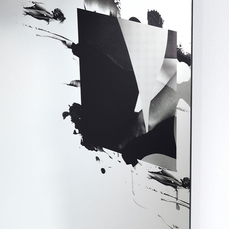 Angled close-up of the Connect III frameless glass wall mirror, 105cm, with a torn black printed form revealing a greyscale photographic image beneath, mounted against a white wall.