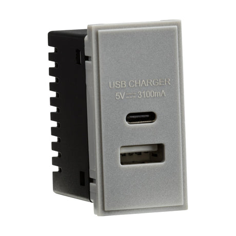 The product is a Dual USB (3.1A) Module 25 x 50mm - Grey, featuring a rectangular dual USB charger with two ports—one USB-A and one Type-C—labeled as USB CHARGER 5V --- 3100mA on the front. It has a light gray faceplate and a black back.