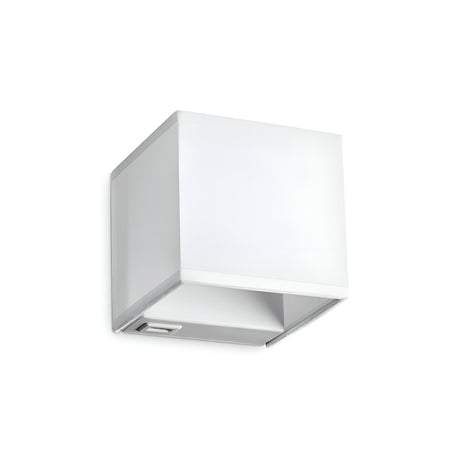 The Sparxis Wall Light - White is a contemporary cube-shaped wall sconce set against a white background, showcasing its minimalist design. This stylish wall light includes a discreet switch at the base and offers a handy USB socket for effortless charging.