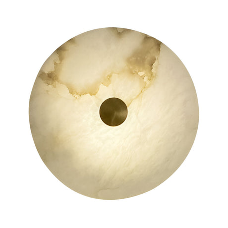 The Caldrisa LED Medium Circular Plate Alabaster Wall Light in Soft White & Brushed Brass features warm Spanish alabaster with a cloudy marbled pattern and a dark center, creating a striking effect when viewed from below.